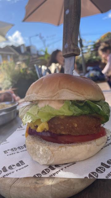 Vegan burger with a knife stabbed through it. Looks delicious.