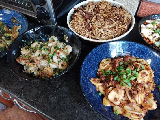 Salt and pepper shrimp to the left, Rice cakes with Shao Hsing rice wine on the right, and Dan Dan noodles in the background.