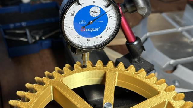 dial test indicator on a 3d printed gear, showing 7.14mm of offset on the high side from the low side