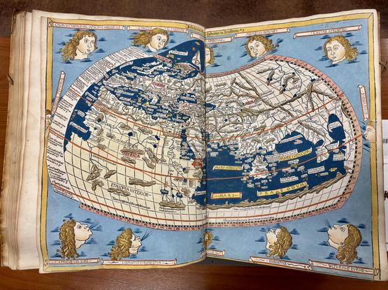 A map of the world as known in Europe in 1482, Europe, Northern Africa, and Western Asia, surrounded by heads representing winds. The ocean is a deep, rich blue.