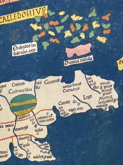 Old map of Scotland showing that what looks like an Easter Egg (probably a representation of a Loch, maybe?) and colourful islands that look like the marshmallows in Lucky Charms floating in the sea.