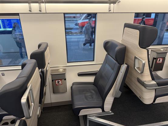 Interior view of a train. There is a single seat which indeed has its own, very narrow window.