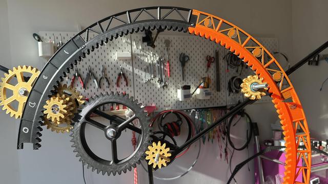 clockwork mechanism with lots of epicyclic gears.  a tool wall hangs in the background