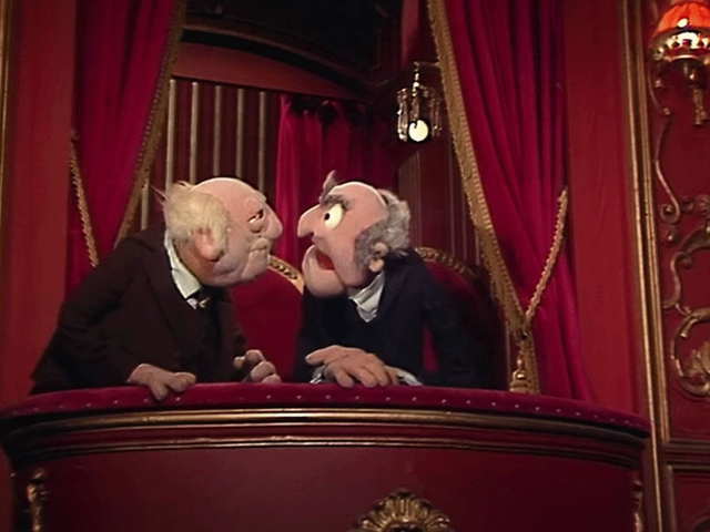 GIF of Statler and Waldorf sitting in their theater box laughing