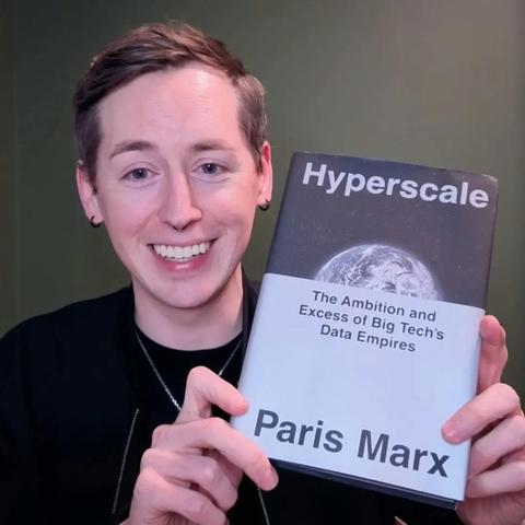 Paris Marx holding his new book Hyperscale: The Ambition and Excess of Big Tech’s Data Empires