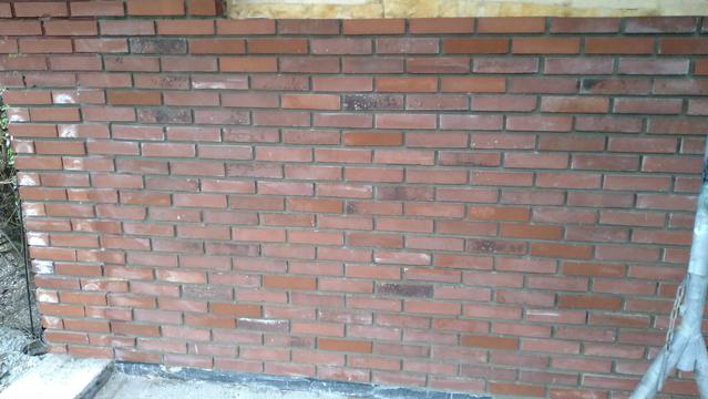 A mixed red brick wall