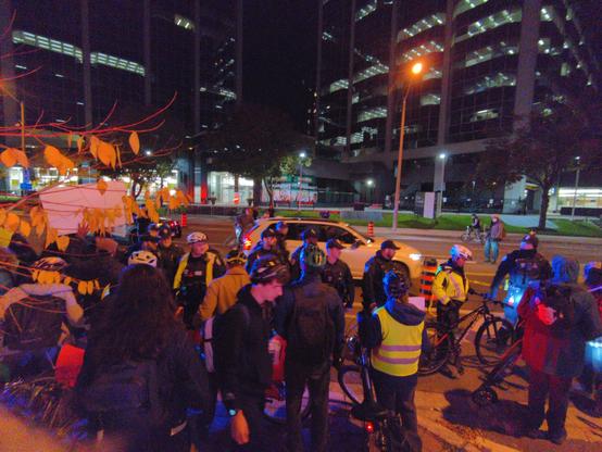 Bike cops pressing a crowd of cyclists and other protesters back onto the sidewalk