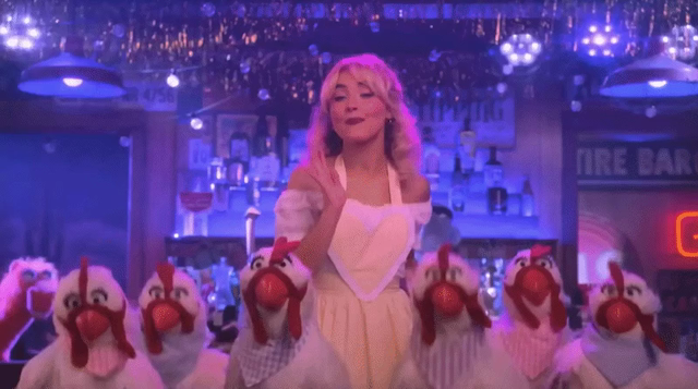GIF of Sabrina Carpenter dancing with a flock of Muppet Chickens