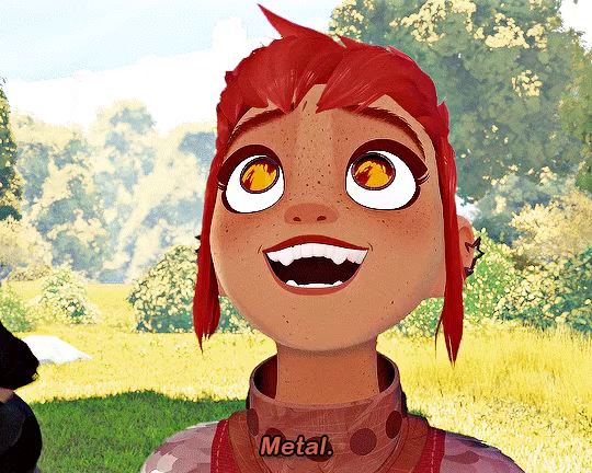 Scene aus dem Film Nimona. Man sieht eine Nimona mit roten Haaren und Feuer das sich in den Augen spiegelt. Darunter steht Metal!
