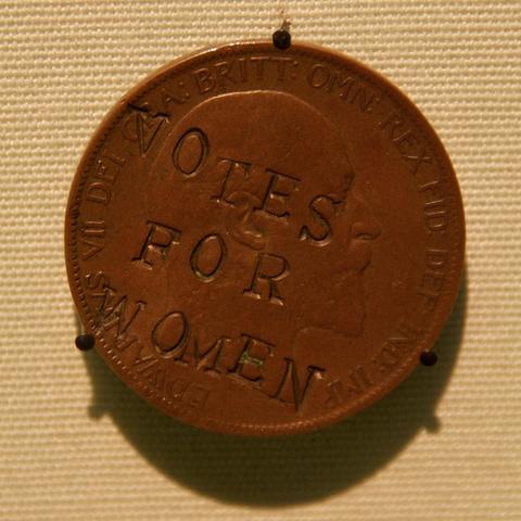 A suffragette penny, with “votes for women” crudely stamped over the head of King Edward VII.