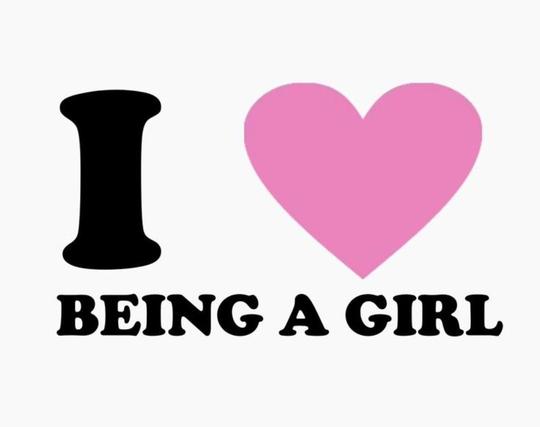 White background with black text that reads " I 🩷 being a girl." The "love" is a pink heart.