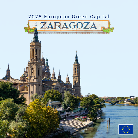 The Cathedral-Basilica of Our Lady of the Pillar in Zaragoza rises beside the Ebro River beneath a blue sky, with its domes and towers framed by trees. Zaragoza is written on decorative tiles and ornaments in the centre of the image with '2028 European Green Capital' appearing above it. There is an EU logo in the lower-right corner.