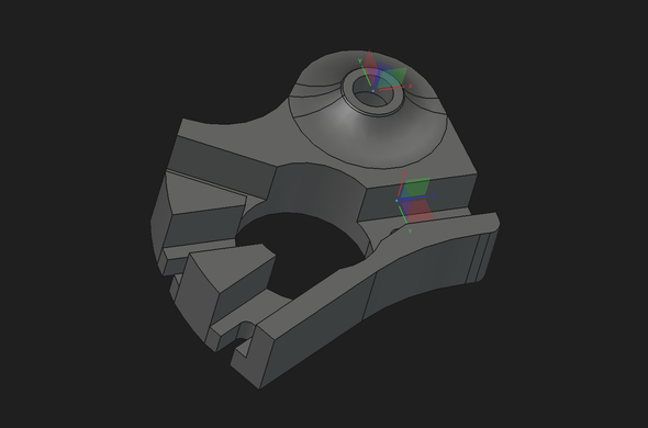 CAD rendernig of a bracket with four channels cut in it and a raised boss for an axle