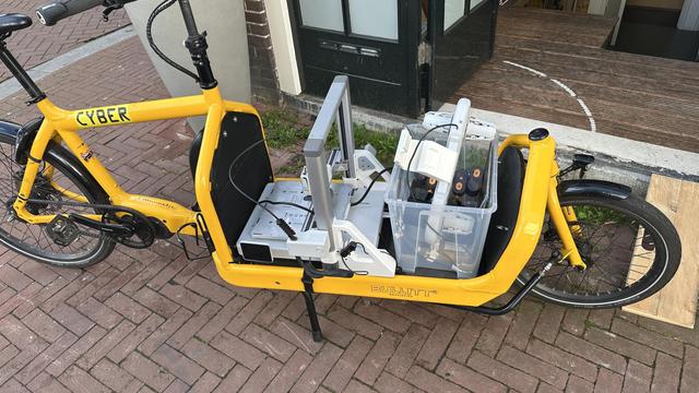 cargo bike with a 3d printer and accessories loaded on the flatbed