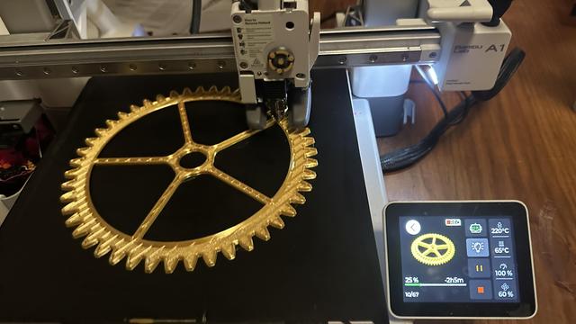 Partially printed giant gear that almost fills the print bed.