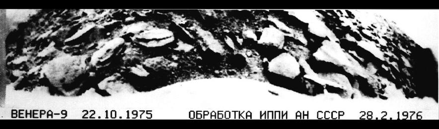 Rocky, boulder-strewn Venusian surface photographed by Soviet Venera‑9 lander in high-contrast black-and-white; caption reads "VENERA‑9 22.10.1975 — processed 28.2.1976."