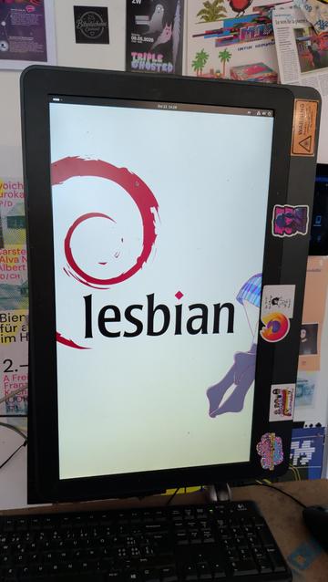Monitor showing os desktop wallpaper "lesbian"