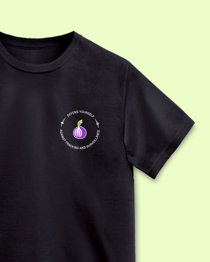 a photo of a black t-shirt with white lettering "defend yourself against surveillance" on a green background