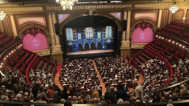 very distant view of a theater stage with multiple levels of seats