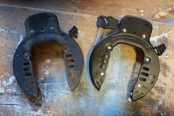 Two identical black bike locks. One is rusty, the other is brand new and unused.