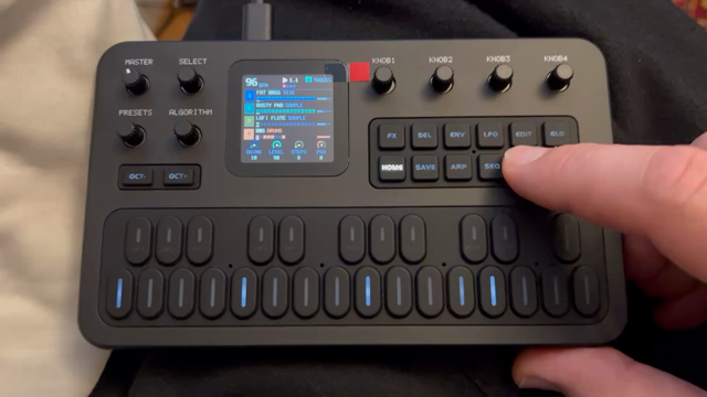 A small black synthesizer with rubber keyboard and a tiny color LCD playing a loop with 4 channels.