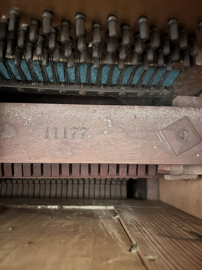 serial number 11177 inscription on the wood inside the piano