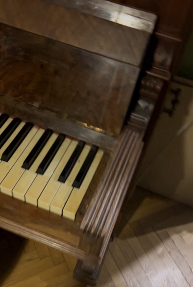 Brown piano with yellowish Ivory keys on the keyboard