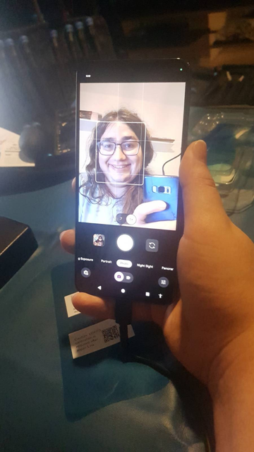 Photo of the fixed Google Pixel 8 Pro, the camera app is open with the selfie cam selected. I am giggling on the screen.